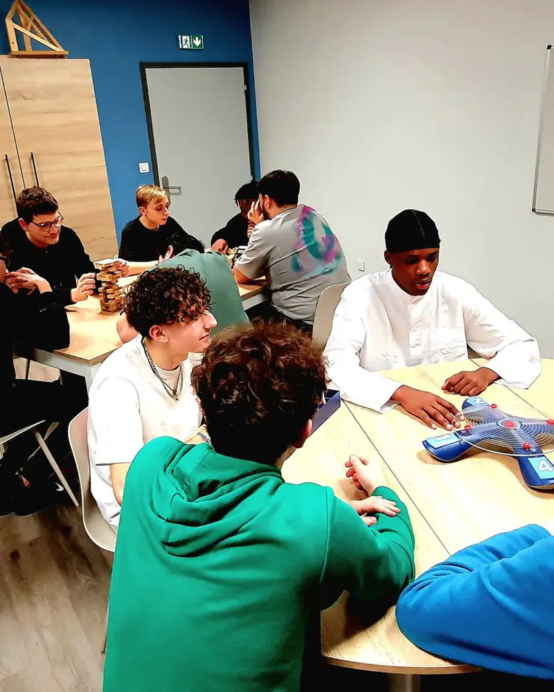 Boarders of Lycée Heinrich Nessel gathered around a board game